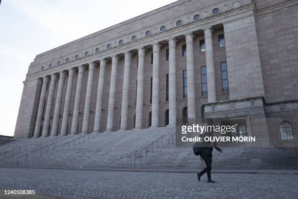 Journalists walk outside Finnish Parliament, during the debate to apply to join NATO , On April 20, 2022 in Helsinki. - The Finnish parliament began...