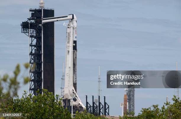 In this handout photo provided by NASA, NASA's Space Launch System rocket with the Orion spacecraft aboard is seen atop a mobile launcher at Launch...