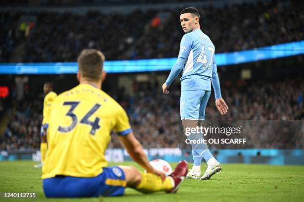 Manchester City's English midfielder Phil Foden reacts after being tackled by Brighton's Dutch defender Joel Veltman and not being rewarded a faul...