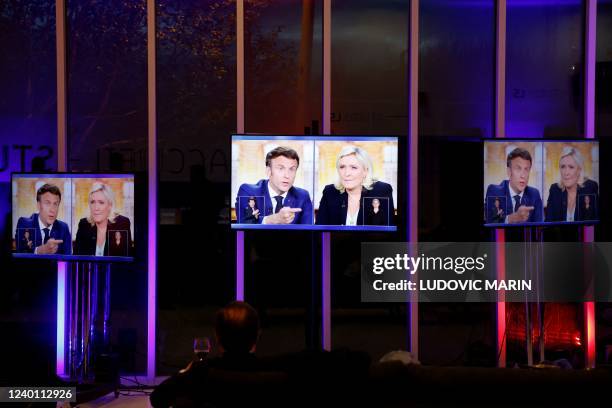 Picture shows screens displaying a live televised debate between French President and La Republique en Marche party candidate for re-election...