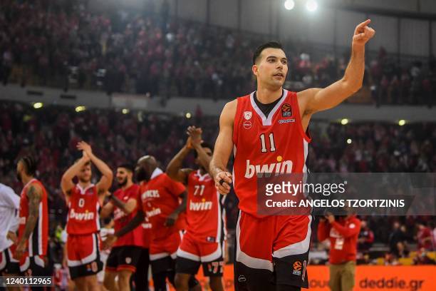 Olympiacos Piraeus' Greek guard Kostas Sloukas celebrates their victory after the Euroleague playoff basketball match between Olympiacos Piraeus and...