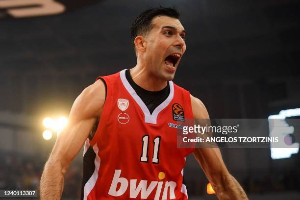 Olympiacos Piraeus' Greek guard Kostas Sloukas celebrates their victory after the Euroleague playoff basketball match between Olympiacos Piraeus and...