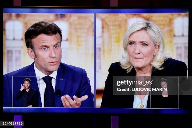 Picture shows a TV screen displaying a live televised between French President and La Republique en Marche party candidate for re-election Emmanuel...