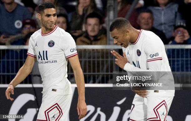 Paris Saint-Germain's French forward Kylian Mbappe celebrates with Paris Saint-Germain's Moroccan defender Achraf Hakimi after scoring his team's...