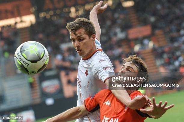Metz's French forward Nicolas de Preville is challenged by Lorient's French defender Vincent Le Goff during the French L1 football match between FC...