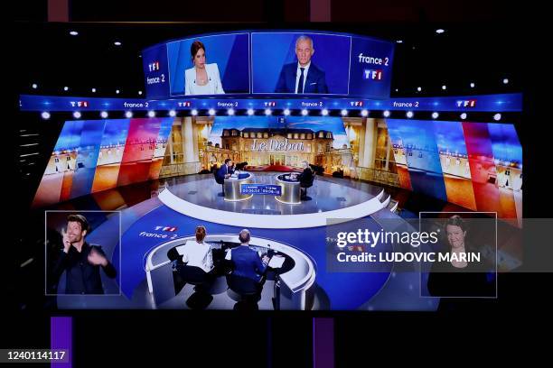 Picture shows screens displaying a live televised debate between French President and La Republique en Marche party candidate for re-election...