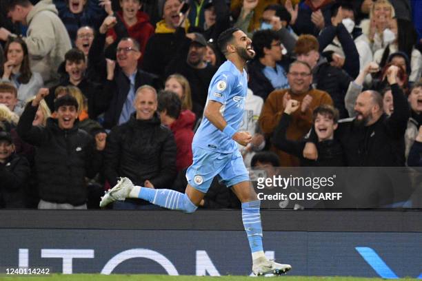 Manchester City's Algerian midfielder Riyad Mahrez celebrates after scoring his team first goal during the English Premier League football match...