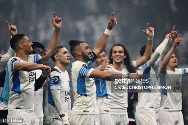 Marseille's French midfielder Dimitri Payet and teammates celebrate with supporters after winning the French L1 football match between Olympique de...