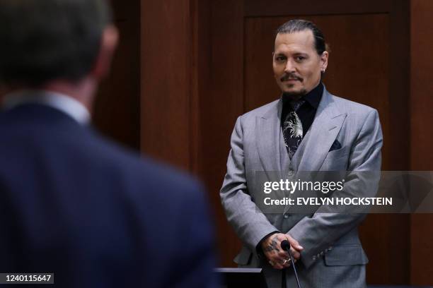 Actor Johnny Depp looks on at the end of the second day of his testimony during the defamation trial against his ex-wife Amber Heard, at the Fairfax...