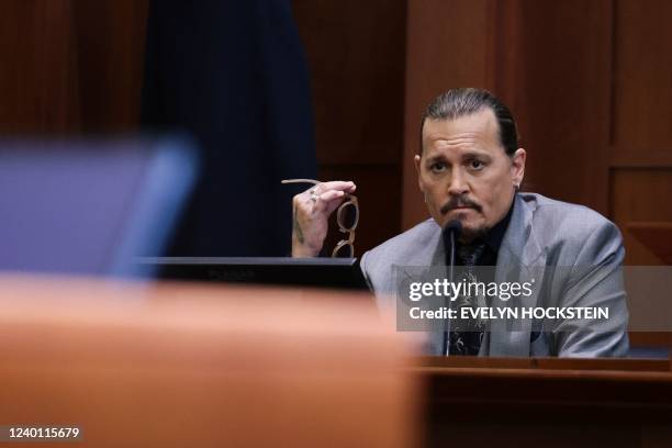 Actor Johnny Depp looks on at the end of the second day of his testimony during the defamation trial against his ex-wife Amber Heard, at the Fairfax...