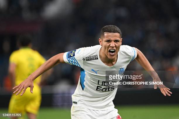 Marseille's French midfielder Amine Harit celebrates his team's third goal during the French L1 football match between Olympique de Marseille and FC...