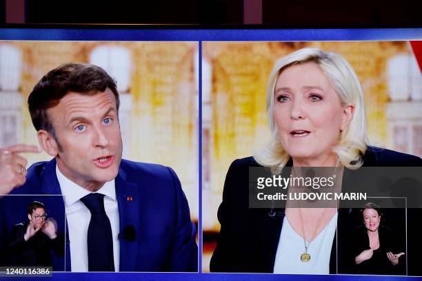 Picture shows a TV screen displaying a live televised between French President and La Republique en Marche party candidate for re-election Emmanuel...