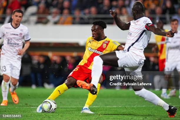 Arnaud Kalimuendo of RC Lens is challenged by Mamadou Sakho of Montpellier during the Ligue 1 Uber Eats match between RC Lens and Montpellier HSC at...