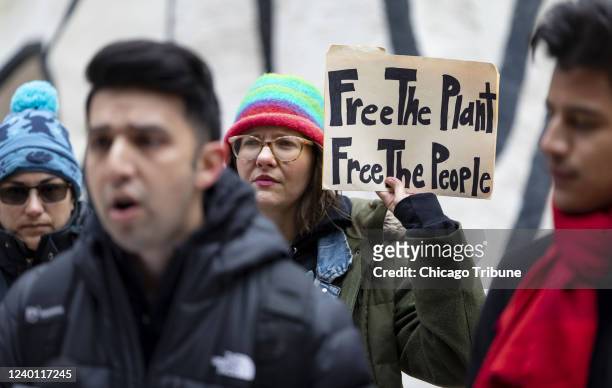 Anna Rose Li-Epstein holds a sign Tuesday, March 29 during a rally outside the Thompson Center by the group True Social Equity in Cannabis, demanding...