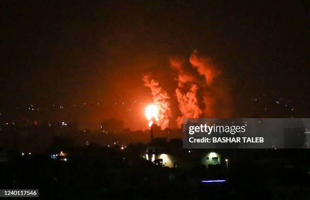 Flames and smoke rise during Israeli airstrikes central Gaza strip in on April 21, 2022. - Israeli jets struck Gaza in the early hours of April 21,...