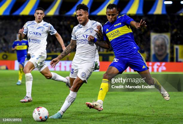 Sebastian Villa of Boca Juniors fights for the ball with Nestor Breitenbruch of Godoy Cruz during a match between Boca Juniors and Godoy Cruz as part...