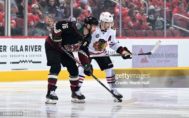 Andrew Ladd of the Arizona Coyotes defends Patrick Kane of the Chicago Blackhawks during the opening face off at Gila River Arena on April 20, 2022...