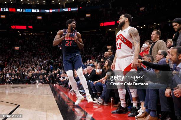 Fred VanVleet of the Toronto Raptors looks on as Joel Embiid of the Philadelphia 76ers celebrates a three-pointer in the final seconds of overtime in...