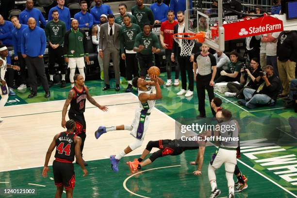 Giannis Antetokounmpo of the Milwaukee Bucks drives to the basket and commits a charging foul on Alex Caruso of the Chicago Bulls during Round 1 Game...