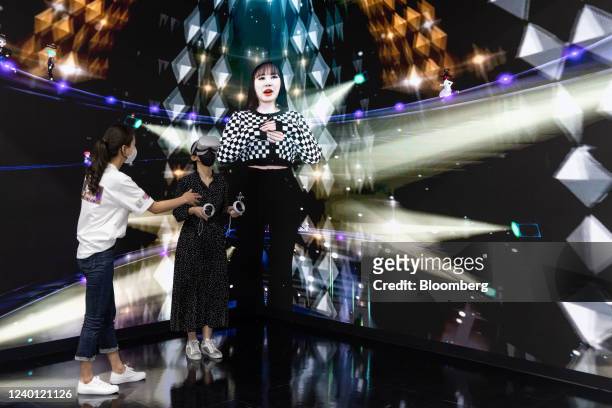 Visitor wearing a virtual reality headset views a concert at the SK Telecom Co. Booth in the World IT Show 2022 in Seoul, South Korea, on Thursday,...