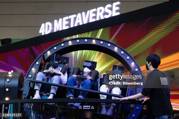 Visitors wear a virtual reality headset at the SK Telecom Co. Booth in the World IT Show 2022 in Seoul, South Korea, on Thursday, April 21, 2022. The...