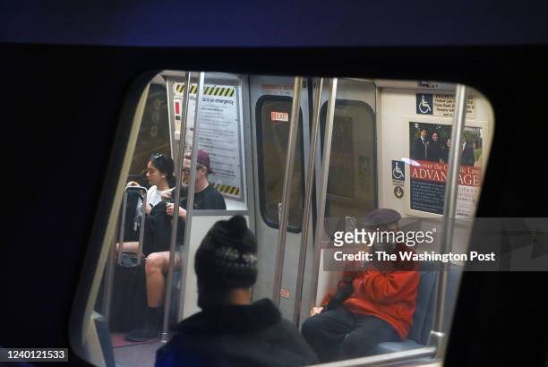 Riders with and without masks ride a train at Metro Center Station on Tuesday April 19, 2022 in Washington, DC. Metro has lifted the mask mandate for...