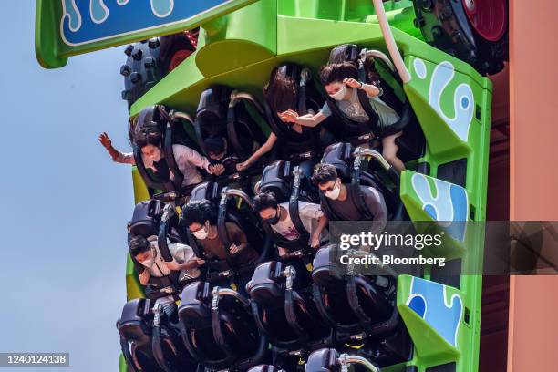 Visitors wearing protective masks ride the RC Racer ride in Toy Story Land at Walt Disney Co.'s Disneyland Resort during its reopening in Hong Kong,...