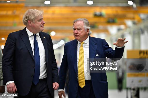Prime Minister Boris Johnson walks along with JCB chairman Lord Bamford , JCB chief executive officer for India, Deepak Shetty and the chief minister...