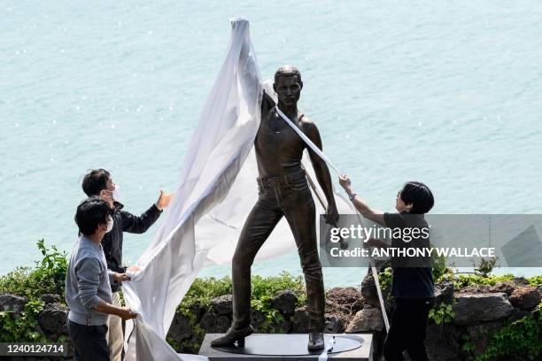 Statue of British rock group Queen's lead singer Freddie Mercury is unveiled by organisers outside a restaurant on the northern coast of Jeju on...