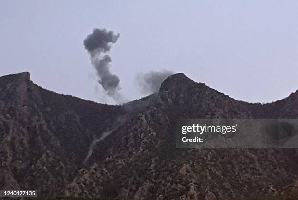 Picture taken on April 19, 2022 shows smoke billowing from behind the mountains of Matin in the town of Chiladze following a Turkish offensive...