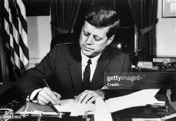 President John Fitzgerald Kennedy signs the order of a naval blockade of Cuba, on October 23, 1962 in White House, Washington DC, during the Cuban...