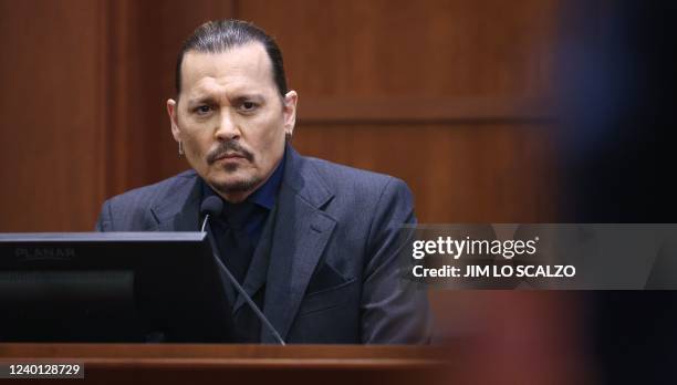 Actor Johnny Depp testifies during his defamation trial against his ex-wife Amber Heard, at the Fairfax County Circuit Courthouse in Fairfax,...