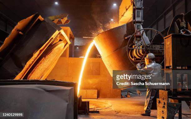 Worker pours molten iron into a mould at the Siempelkamp Giesserei foundry on April 21, 2022 in Krefeld, Germany. The Siempelkamp foundry is one of...