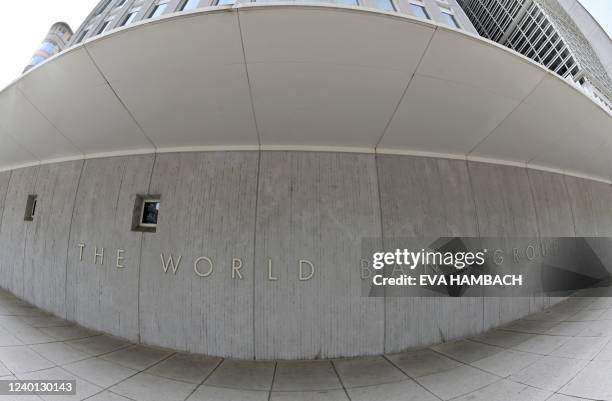 The World Bank Group logo appears on the building in Washington, DC on April 21, 2022. - The 2022 Spring Meetings of the World Bank Group and the...