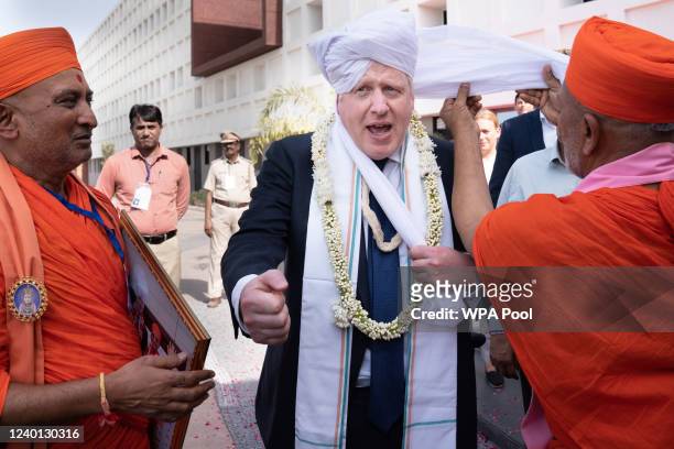 Prime minister Boris Johnson having a turban placed on his head at Gujarat Bio Technology University, during his two day trip to India on April 21,...