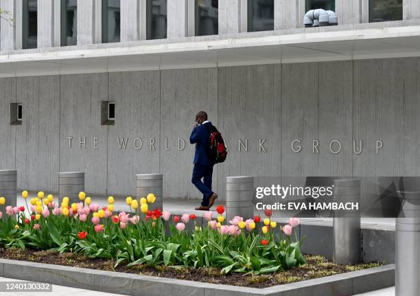 Man walks past the World Bank building in Washington, DC on April 21, 2022. - The 2022 Spring Meetings of the World Bank Group and the International...