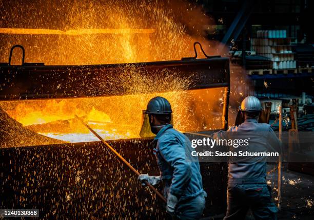 Workers prepare to pour ductile iron casting molten iron into a mould at the Siempelkamp Giesserei foundry on April 21, 2022 in Krefeld, Germany. The...