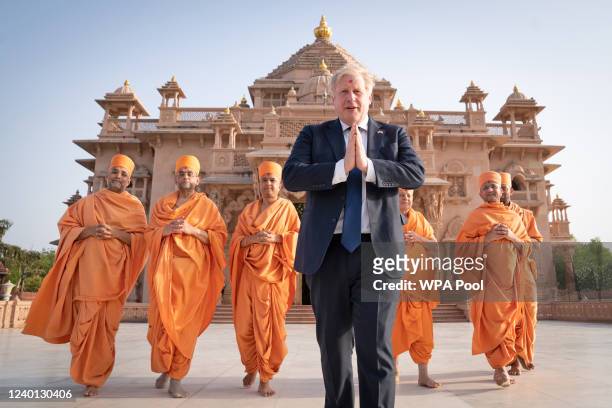 Shoeless UK prime minister Boris Johnson walks with sadhus, Hindu holymen, as he visits the Swaminarayan Akshardham temple during his two day trip to...