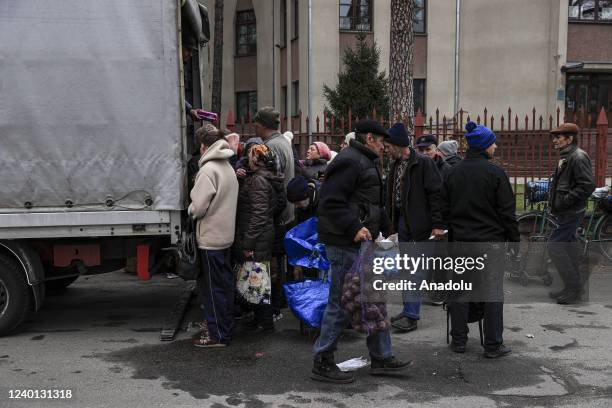 People receive food aid packages distributed after Ukrainian army regained control of Bucha city, of Kyiv Oblast, Ukraine on April 20, 2022.