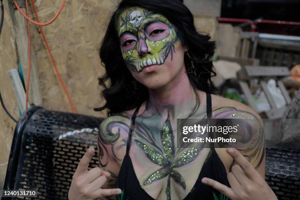 Painted woman poses outside Plantón 420 outside the Senate of the Republic in Mexico City, during the commemoration of International Marijuana Day,...