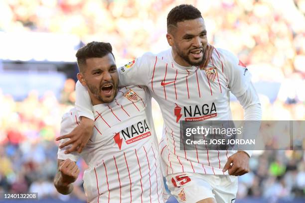 Sevilla's Mexican forward Jesus Manuel Corona aka Tecatito celebrates with Sevilla's Moroccan forward Youssef En-Nesyri after scoring his team's...