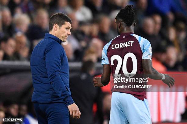 Burnley's Ivorian defender Maxwel Cornet speaks with Burnley's Interim manager Mike Jackson during the English Premier League football match between...