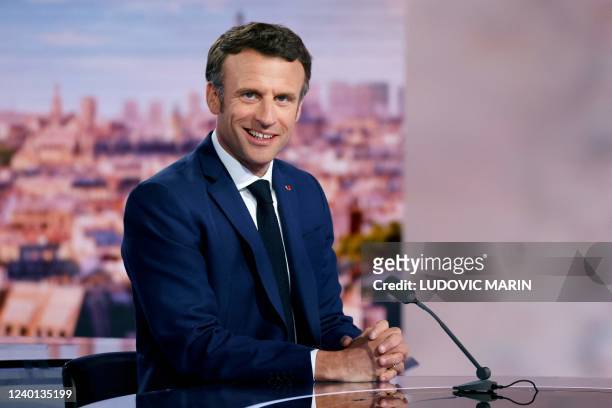 French President and La Republique en Marche party candidate for re-election Emmanuel Macron poses prior to taking part in the evening news broadcast...