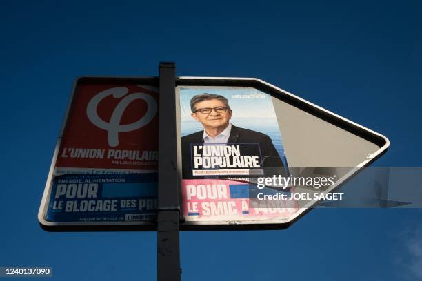 This photograph taken on April 21, 2022 in Paris shows former campaign posters of France's leftist movement La France Insoumise candidate for the...