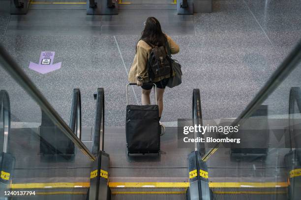 Traveler at Logan International Airport in Boston, Massachusetts, U.S., on Thursday, April 21, 2022. Some transit agencies across the U.S. Are...