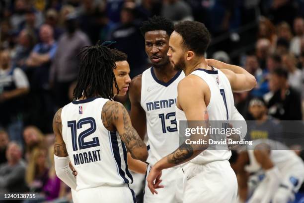 Ja Morant, Jaren Jackson Jr. #13, and Kyle Anderson of the Memphis Grizzlies huddle during the first quarter of Game Three of the Western Conference...