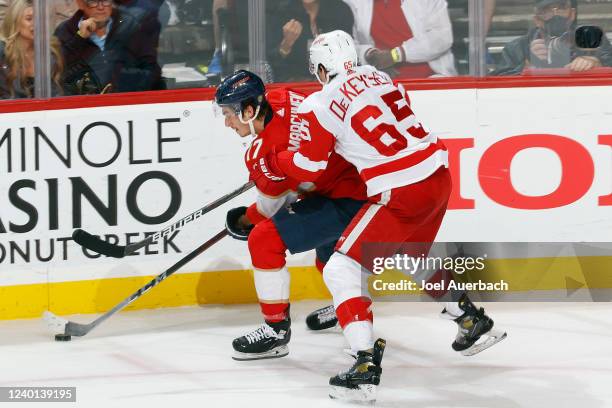 Danny DeKeyser of the Detroit Red Wings defends against Mason Marchment of the Florida Panthers as he skates with the puck during second period...