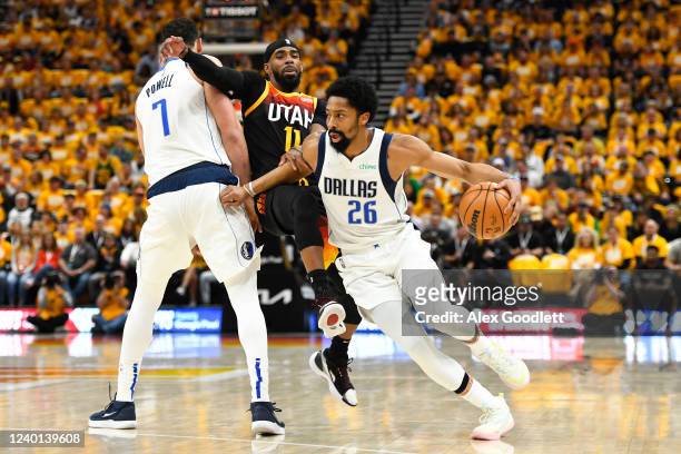 Spencer Dinwiddie of the Dallas Mavericks drives around Mike Conley of the Utah Jazz during the first half of Game Three of the Western Conference...