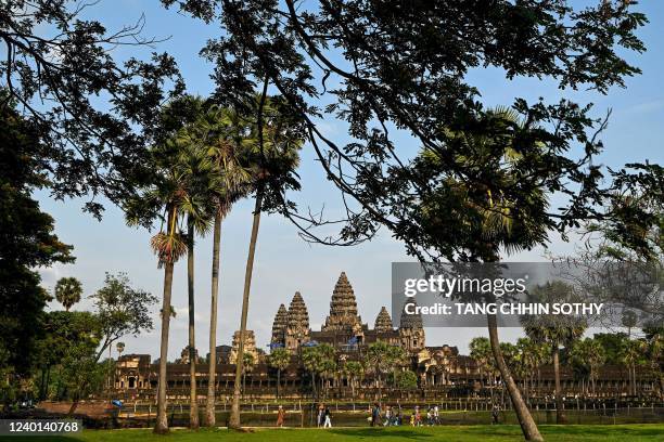 This picture taken on April 7, 2022 shows a general view of tourists visiting the Angkor Wat temple complex, a UNESCO World Heritage Site, in Siem...