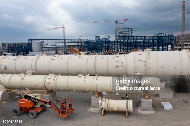 April 2022, Saxony-Anhalt, Leuna: Several distillation columns, the largest with a future height of 60 meters, are being prepared for installation on...